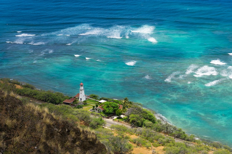 a lighthouse on a cliff overlooking the ocean